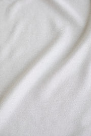 IRIS SILVER WHITE SLIGHTLY GLITTERING VISCOSE-BLEND PEPLUM TOP WITH A BELT